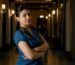 woman in blue shirt standing on hallway